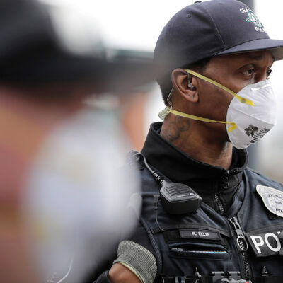 Two Seattle police officers wearing N95 masks.