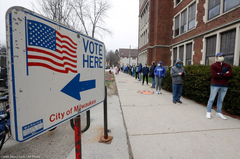 Voters line up outside of a polling station in Milwaukee for Wisconsin's primary election.