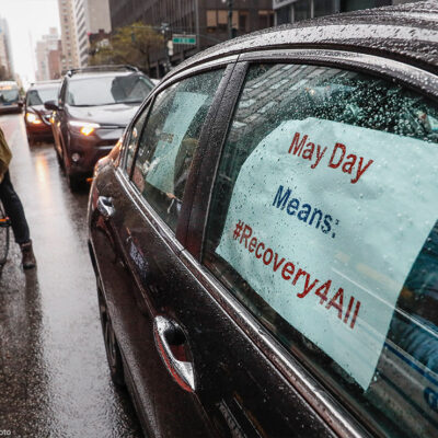 A caravan of May Day protestors drive up 2nd Avenue in New York City during COVID pandemic.