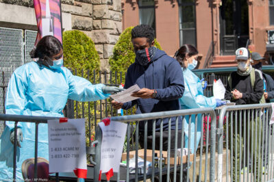Medical personnel help residents sign up for a COVID-19 test outside of a church in Brooklyn, New York.