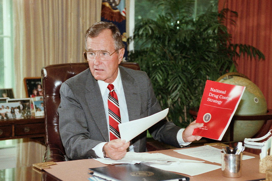 President George H. Bush holds up a copy of the National Drug Control Strategy