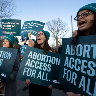 Abortion rights demonstrators hold "abortion access for all" signs at rally outside of the U.S. Supreme Court.