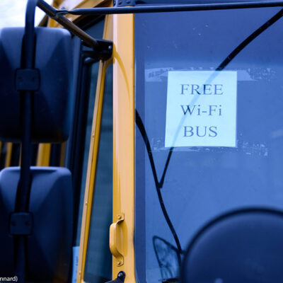 A sign on a school bus displays "FREE WIFI BUS"