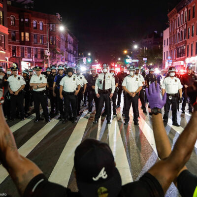 Protesters take a knee on Flatbush Avenue in front of New York City police officers during a solidarity rally for George Floyd