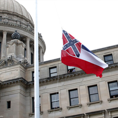 The retired Mississippi state flag is raised over the Capitol grounds one final time in Jackson, Mississippi