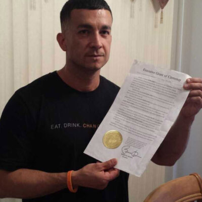 Jason Hernandez holding his executive grant of clemency given by President Barack Obama.