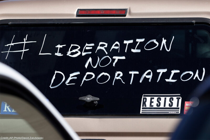 A car windshield with the hashtag "liberation not deportation" painted on it