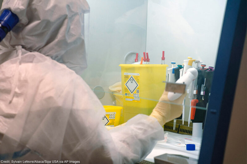 Scientists at work in high-level P3 biosafety security laboratory.