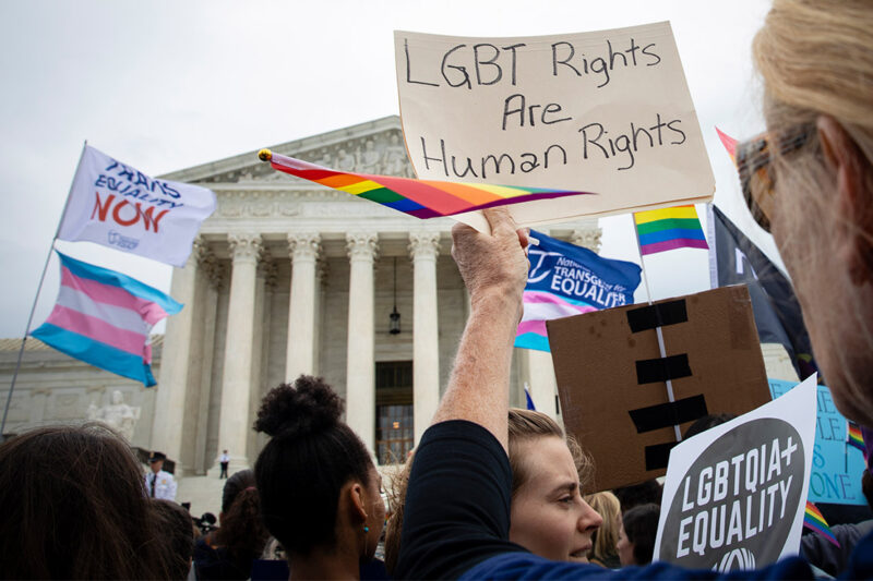 Demonstrators outside the Supreme Court with signs advocating for the rights of LGBT people.