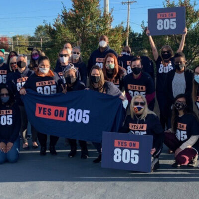 A group of people wearing shirts and carrying banners that read "Yes on 805" referring to Oklahoma's Question 805 on the ballot.