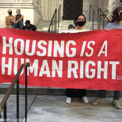 Protestors hold aloft a saying HOUSING IS A HUMAN RIGHT at a protest in New York City, September 2, 2020