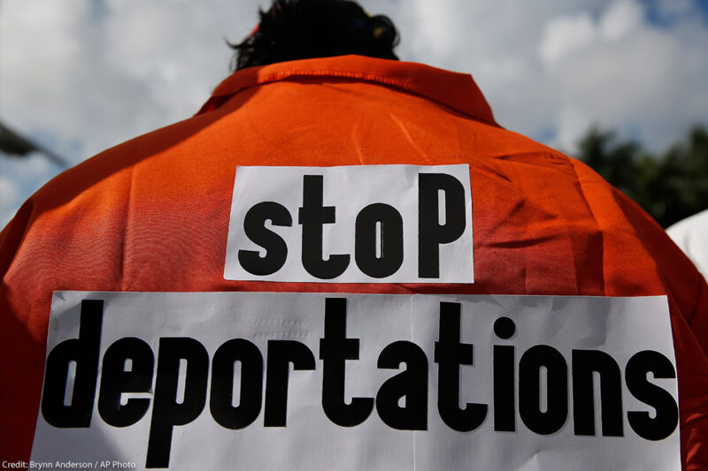 Juan Correa Villalonga wears an orange jumpsuit the says "stop deportations" on the back in protest against the ICE agents deporting Venezuelans.
