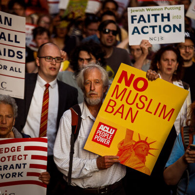 People protest during a rally about the U.S. Supreme Court's decision to uphold President Donald Trump’s ban on travel from several mostly Muslim countries.