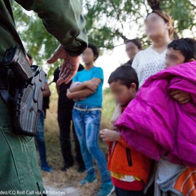 A Customs and Border Protection officer questions immigrants in Rio Grande Valley sector of the Texas border on Aug. 20, 2019.