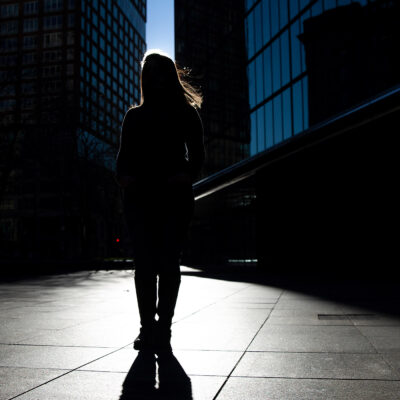 Silhouette of Farah, one of the woman in this blog, standing in front of skyscrapers