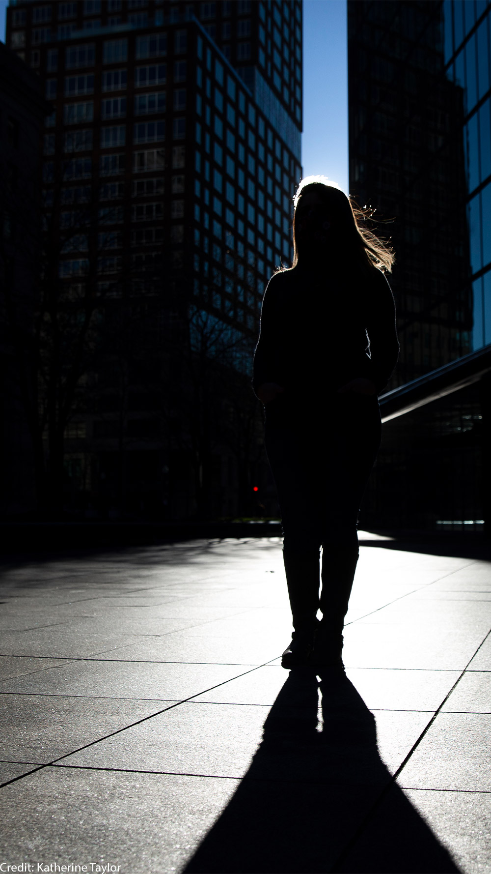 Silhouette of Farah, one of the woman in this blog, standing in front of skyscrapers