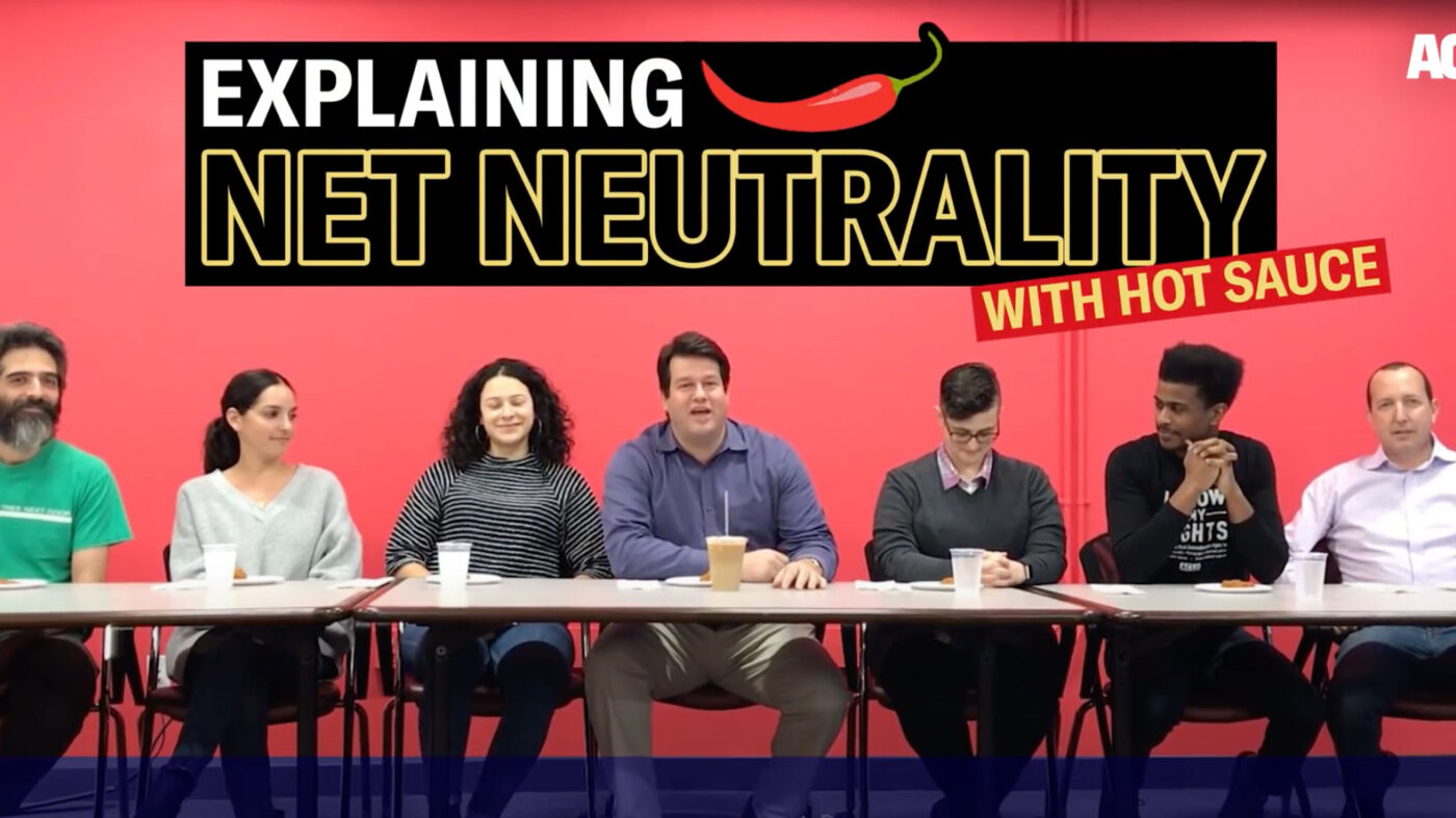 ACLU lawyers sit at a table to break down net neutrality to viewers.