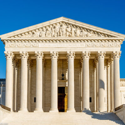 Photo of the front of the Supreme Court building on a sunny day