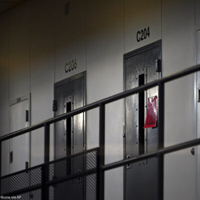 A red tag hangs on a cell door, signifying an active COVID-19 case for its inhabitants in the Minnesota prison.