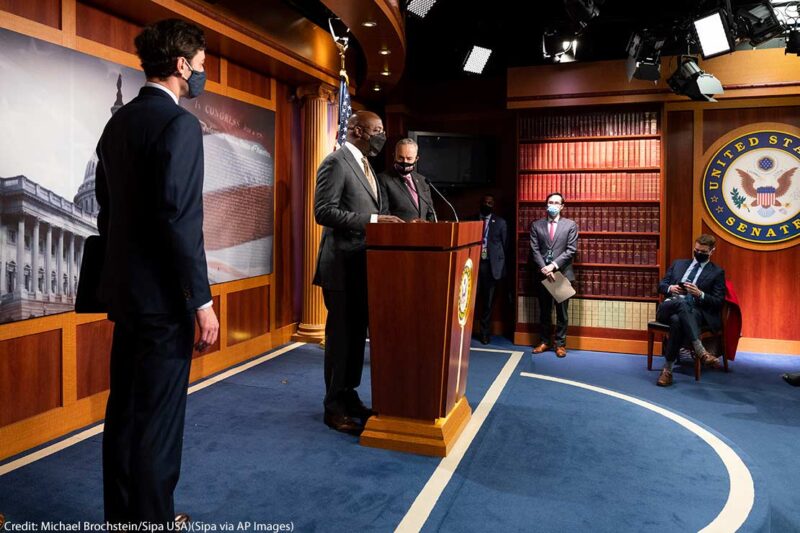 U.S. Senator Raphael Warnock (D-GA) speaking, with U.S. Senator Jon Ossoff (D-GA) and Senate Majority Leader Chuck Schumer (D-NY) standing next to him, about the COVID-19 relief legislation being worked on in the Senate, on February 11. 2021.