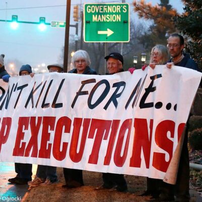 Protestors holding a banner with the text "Don't kill for me...Stop executions."