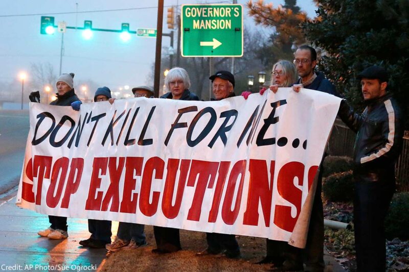 Protestors holding a banner with the text "Don't kill for me...Stop executions."