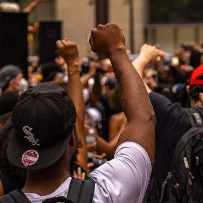 Black man raises fist in the air during a Juneteenth Rally in Chicago