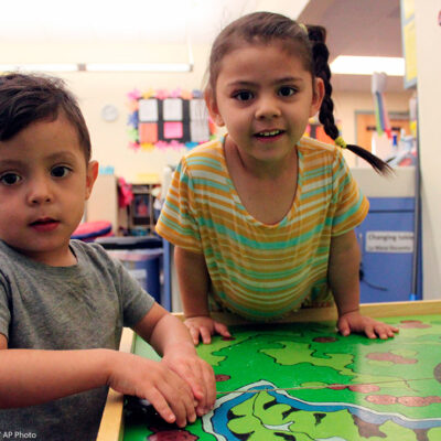 A young boy and girl play with their toy cars to wrap up the day at a day care Albuquerque, New Mexico