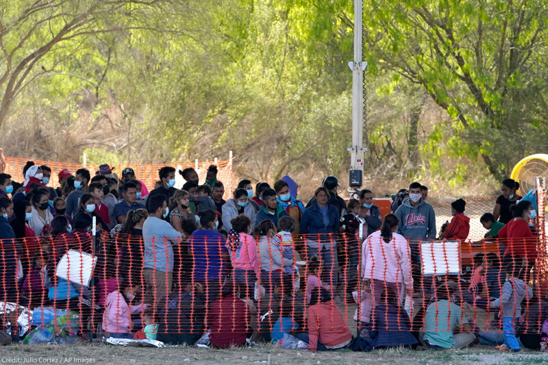 Migrants in custody at U.S. Customs and Border Protection processing area under the Anzalduas International Bridge, Friday, March 19, 2021, in Mission, Texas.