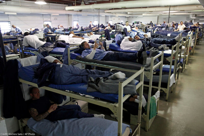 A room full of inmates are seen in their bunk beds