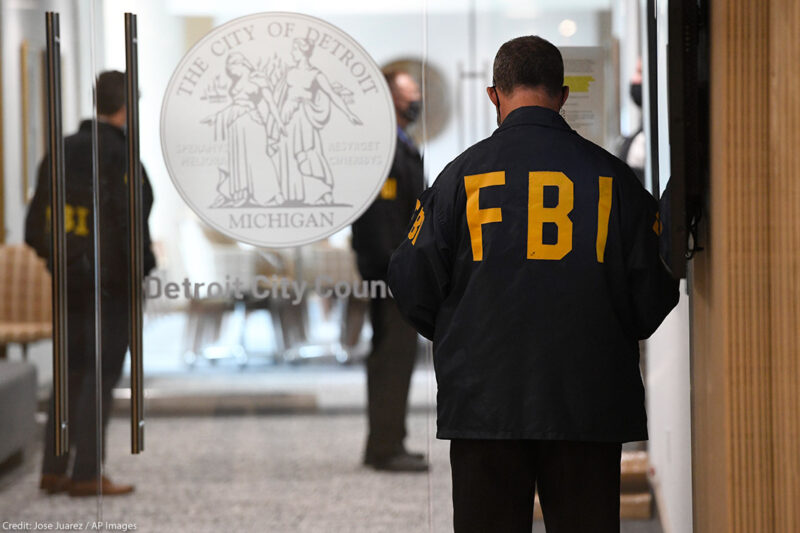 An FBI employee guards the entrance doors to the Detroit City Council on the 13th floor of the Coleman A. Young Municipal Center, Thursday, Aug. 25, 2021, in Detroit.