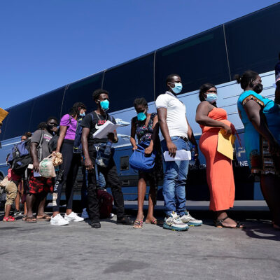 Migrants, many from Haiti, board a bus after they were processed and released after spending time at a makeshift camp near the International Bridge, Monday, Sept. 20, 2021, in Del Rio, Texas.