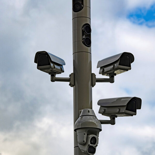 Surveillance cameras on a street pole.