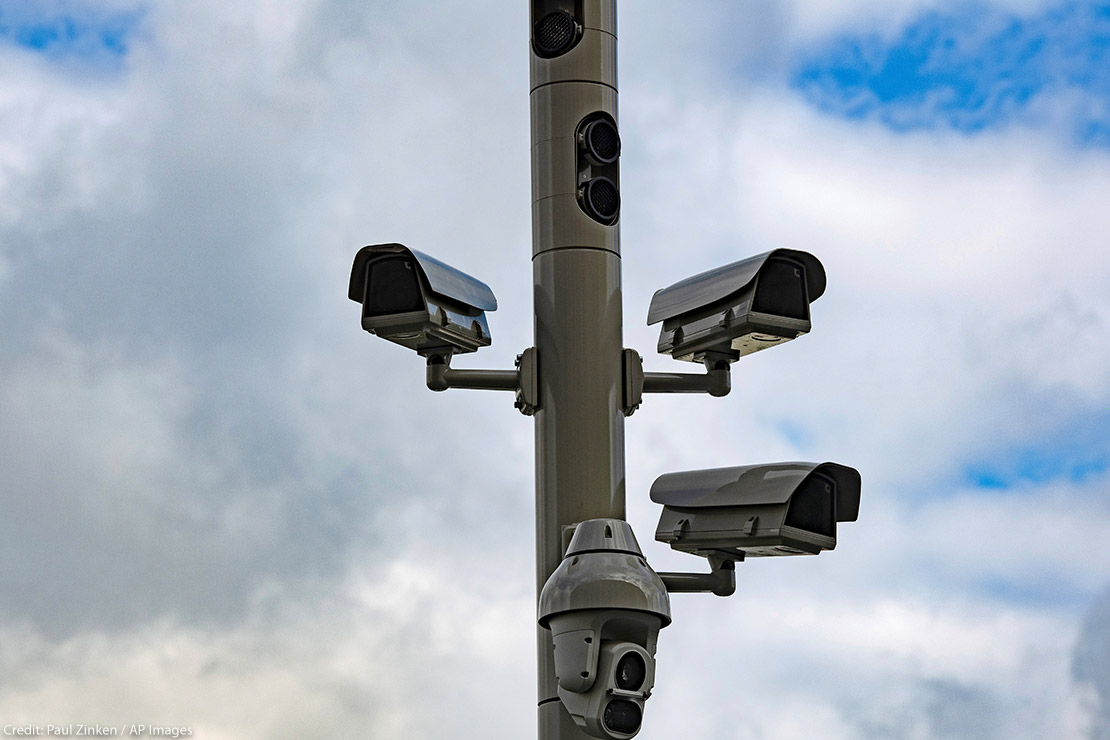Surveillance cameras on a street pole.