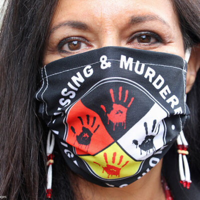Jeannie Hovland, the deputy assistant secretary for Native American Affairs for the U.S. Department of Health and Human Services, poses with a Missing and Murdered Indigenous Women mask.