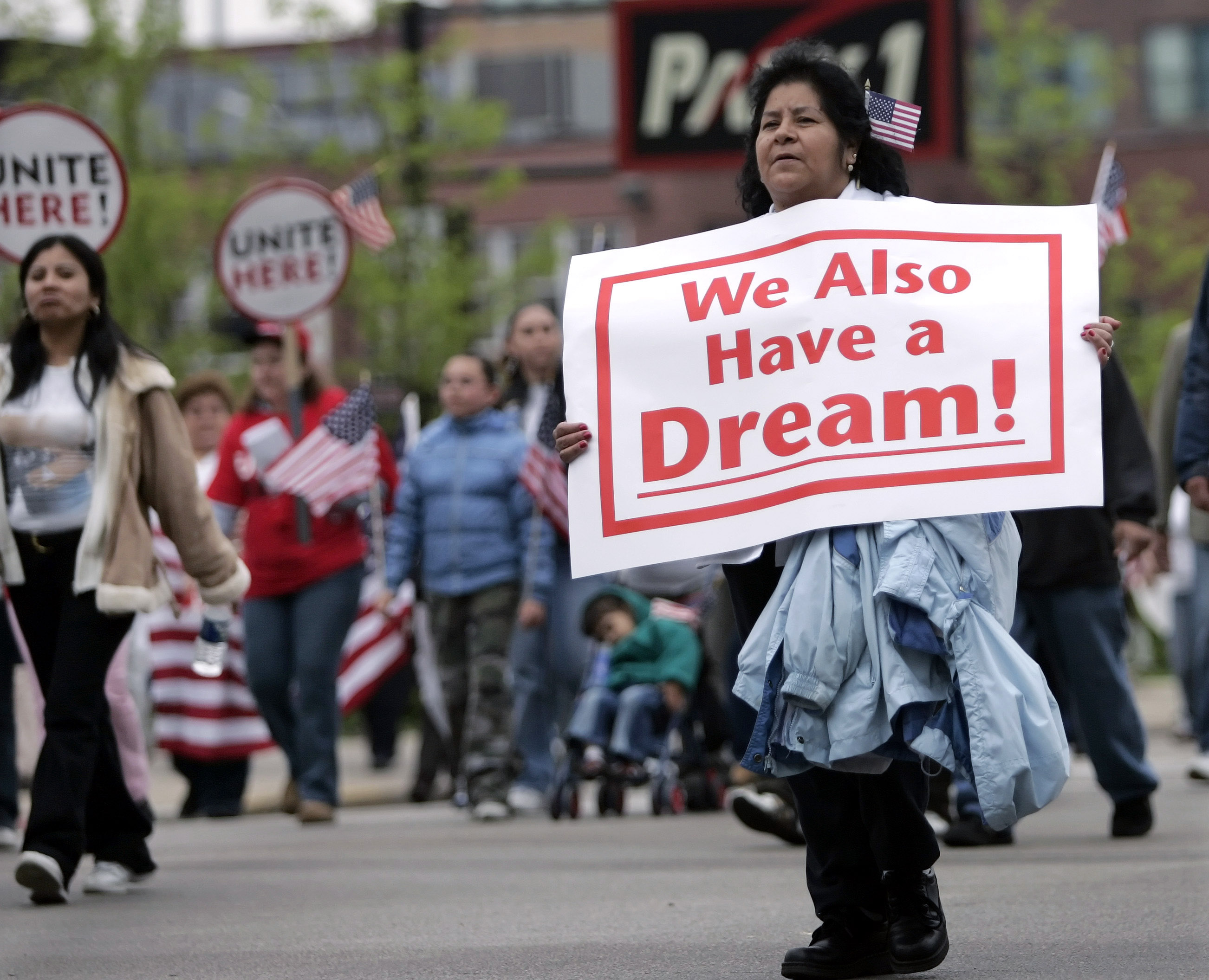 A demonstrator holding a sign saying, "We Also Have a Dream."