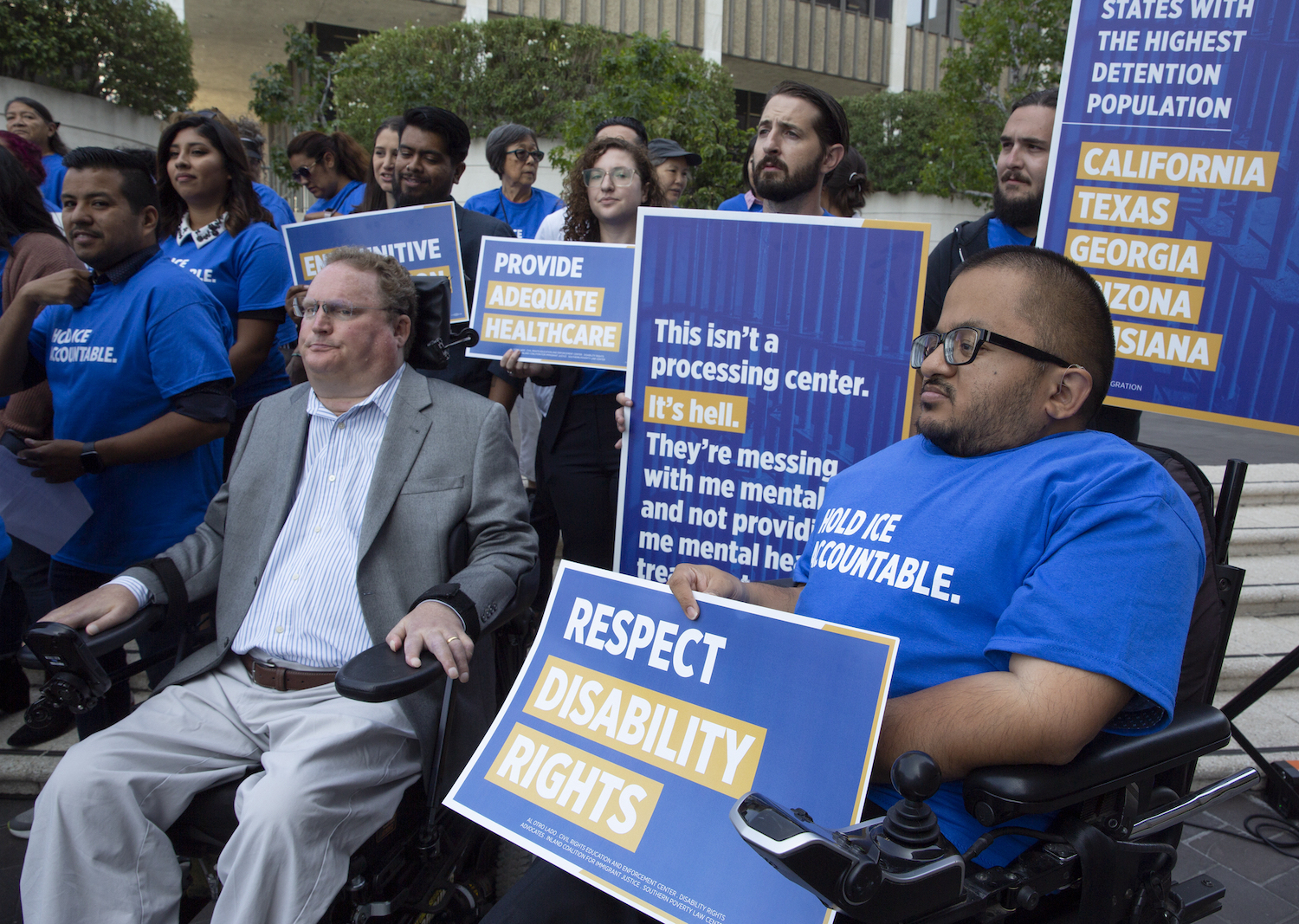 Individuals at a criminal justice and disability rights demonstration, with signs reading "Respect Disability Rights."