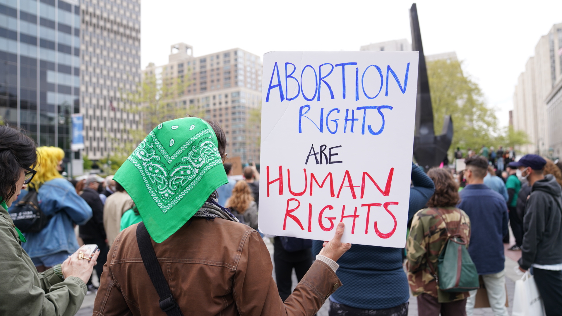 A protester with a sign that reads “Abortion Rights Are Human Rights.”