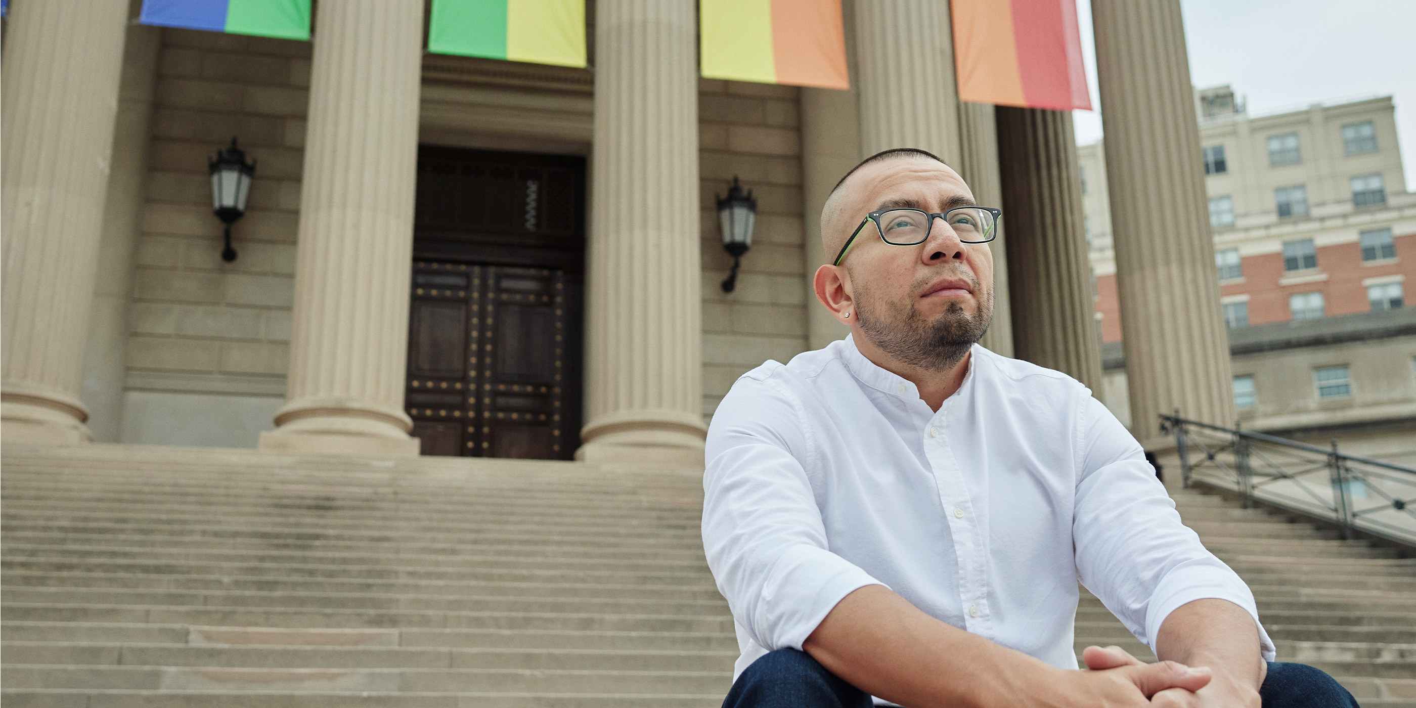 Ricardo Martinez sitting on the steps of a municipal building in Washington, DC.