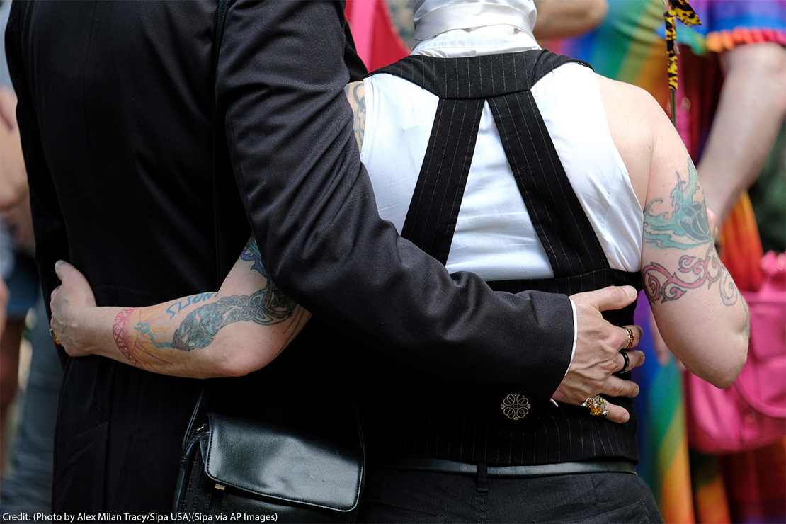 People embrace ahead of the Trans Pride March in Portland, celebrating gender identity.