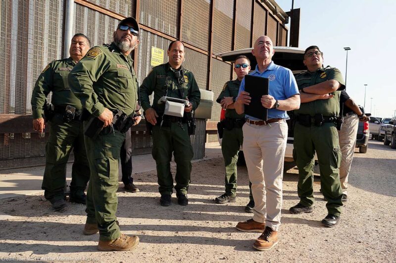 Homeland Security Secretary Alejandro Mayorkas, second from right, looks up along with U.S Border Patrol agents as a drone flies overhead as he tours a section of the border wall Tuesday, May 17, 2022, in Hidalgo, Texas.