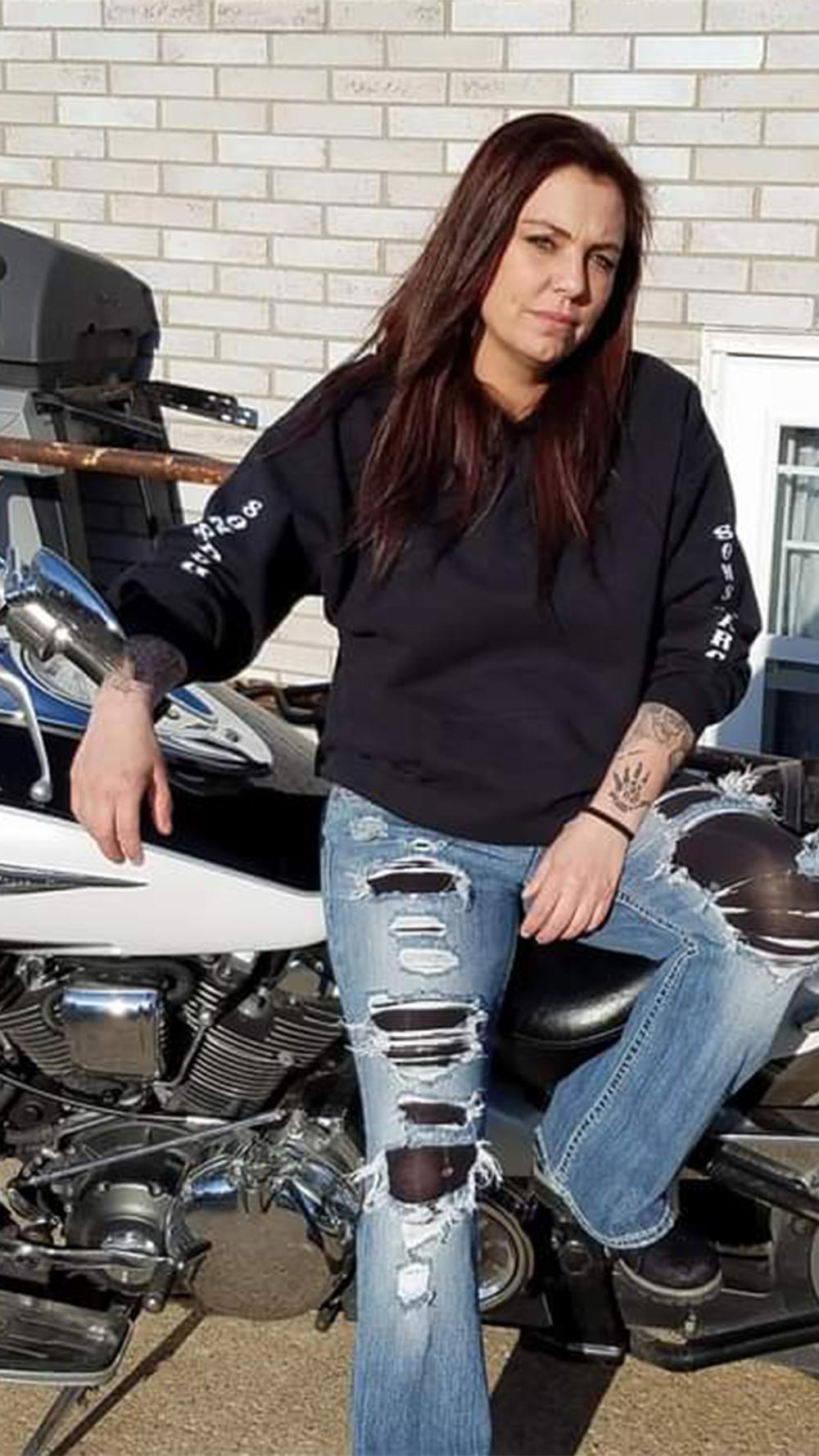 Shannen Davis sitting on a motorcycle.