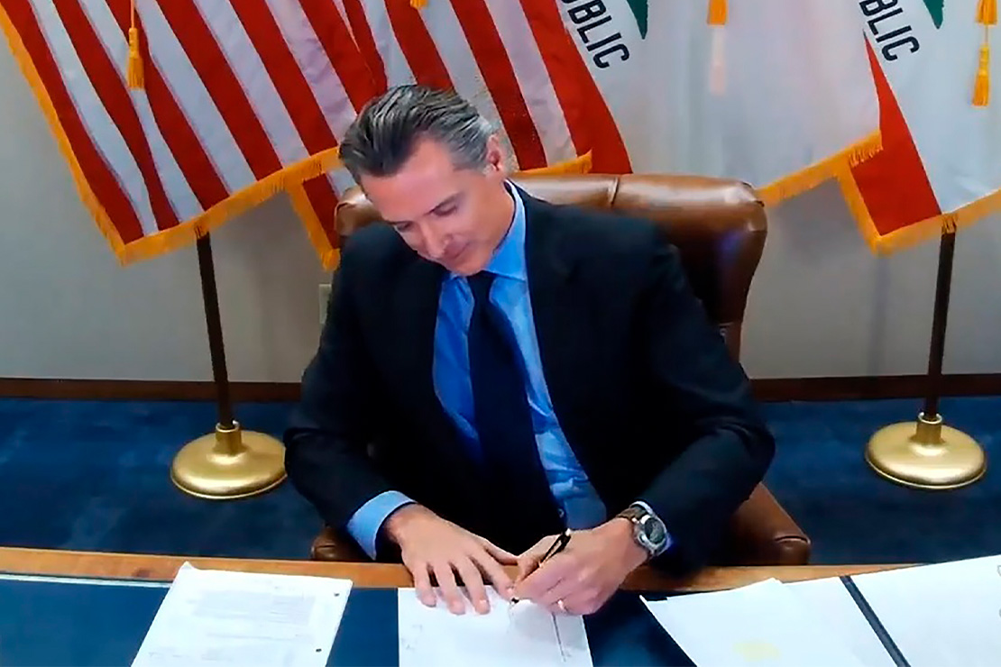 California Gov. Gavin Newsom signing into law the California Racial Justice Act (CRJA).