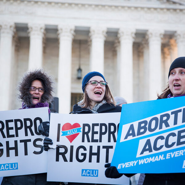 "Abortion Access" and "I heart Repro Rights" signs in front of Supreme Court