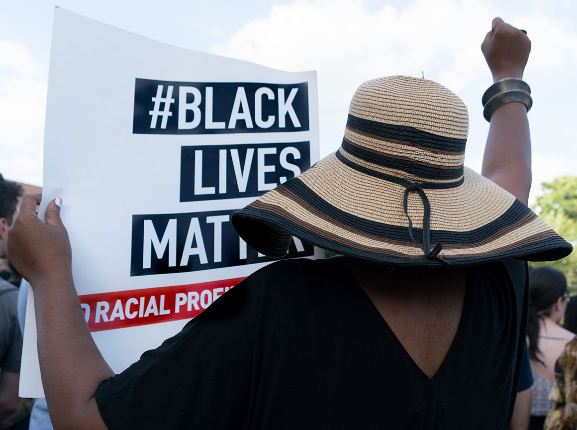 Protester holding "#Black Lives Matter" sign