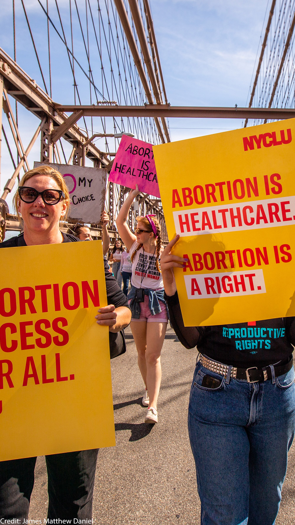Two demonstrators holding pro-abortion signage.