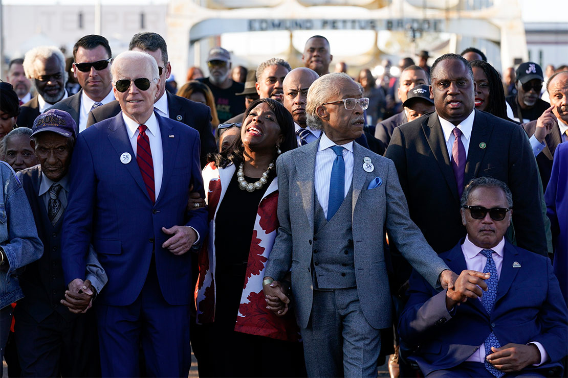 President Joe Biden walks hand-in-hand with Rep. Terri Sewell, D-Ala., the Rev. Al Sharpton, and the Rev. Jesse Jackson and others across the Edmund Pettus Bridge in Selma, Ala., Sunday, March 5, 2023, to commemorate the 58th anniversary of "Bloody Sunday."