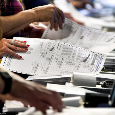 Election workers handle ballots at the Allegheny County Election Division warehouse in Pittsburgh.