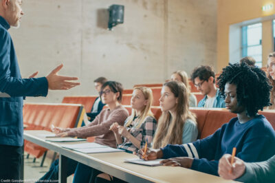 A professor holding a lecture to a group of students.