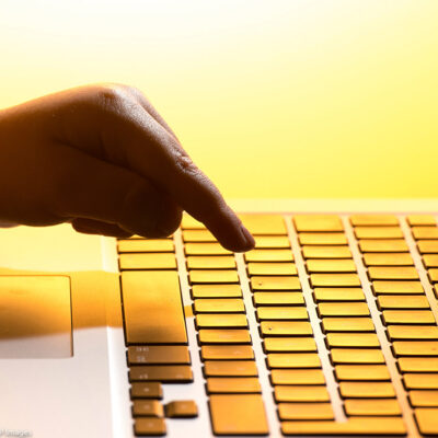 A finger pressign a keyboard.